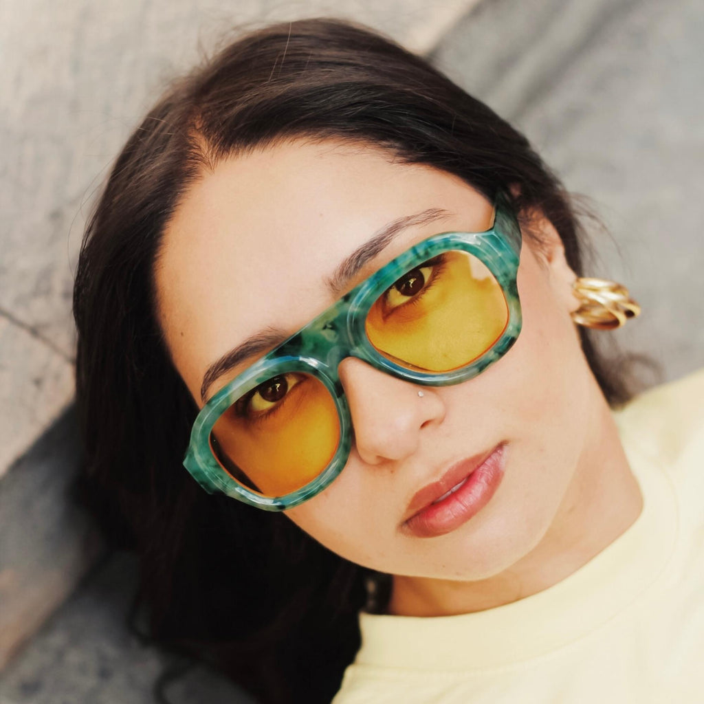 Lunettes de soleil aviateur vert marbré La Rivoli portées par une femme avec verres jaunes teintés